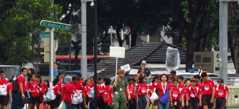 A group of people in red shirts and hats.