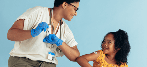 A doctor is giving a child something to touch.