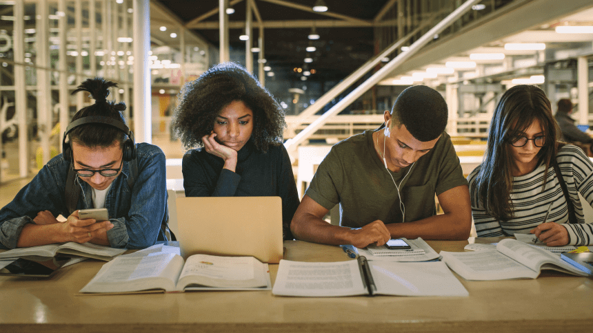 A group of people sitting at a table with papers.