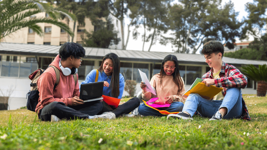 A group of young people sitting on the grass.