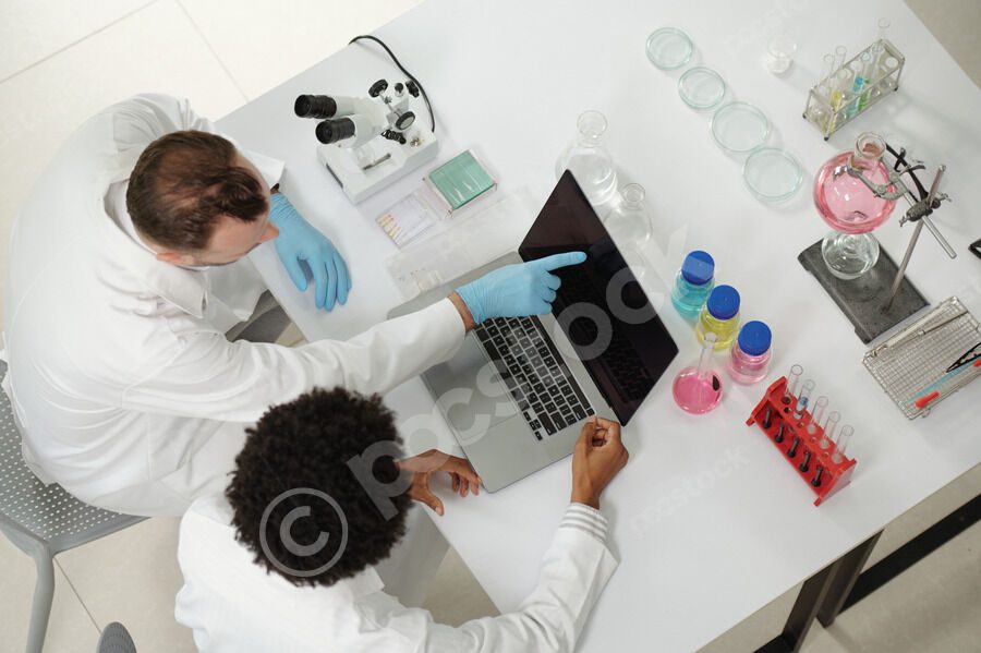 Scientists collaborating in a laboratory with laptop.
