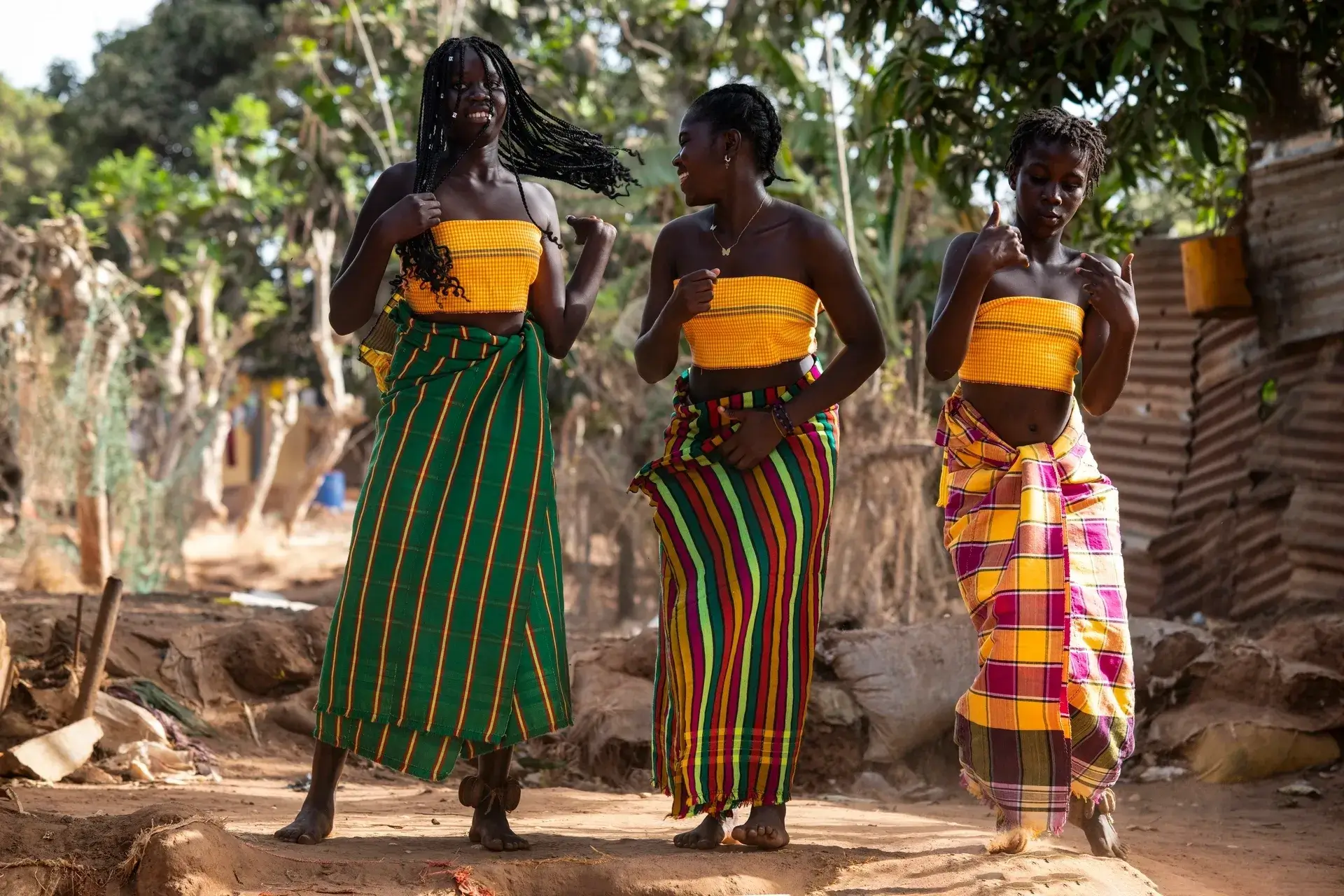 Women in colorful traditional attire walking outdoors.